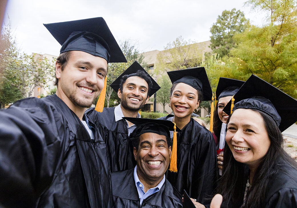 Before going their separate ways after graduation, the diverse friends group takes a selfie.