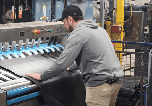 Wisconsin State Sen. Patrick Testin (R) works at a mat-rolling station at the UniFirst plant in Wisconsin Rapids.