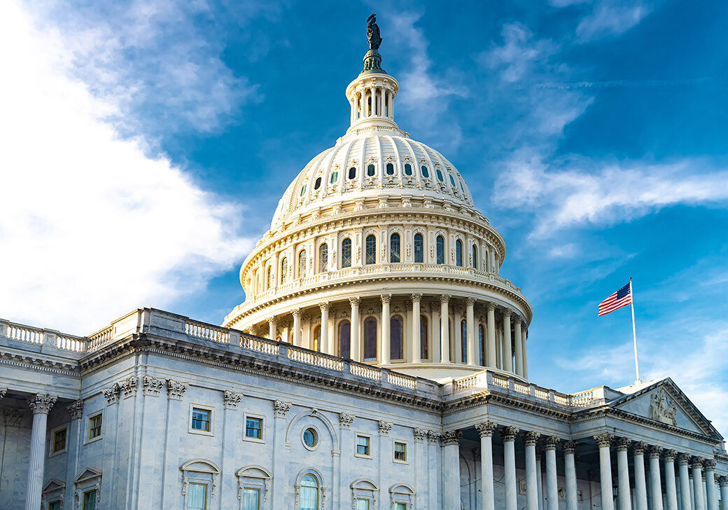 view of the Capitol dome and the national flag in Washington, D.C., USA.