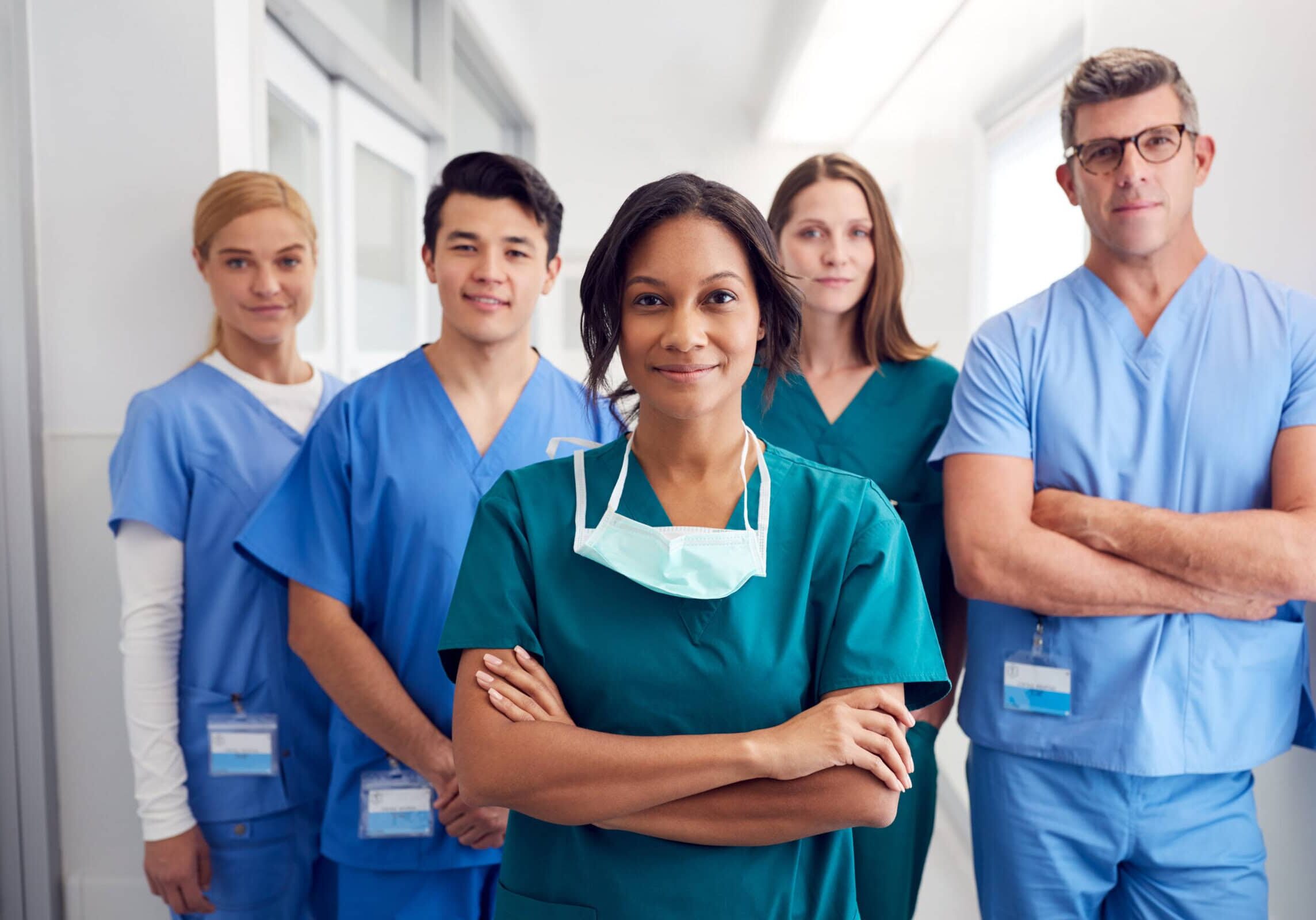 Portrait Of Multi-Cultural Medical Team Standing In Hospital Corridor