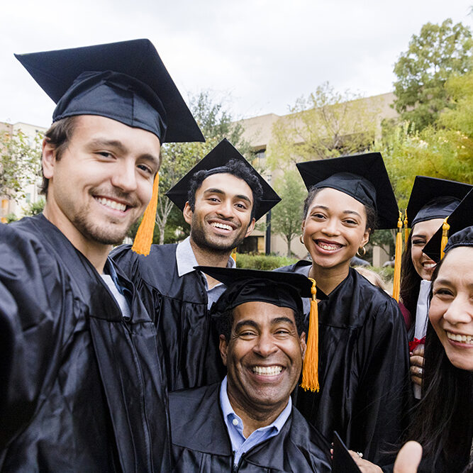 Before going their separate ways after graduation, the diverse friends group takes a selfie.